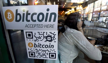 A Bitcoin ATM sticker is posted to the window of a coffee shop in Vancouver.
