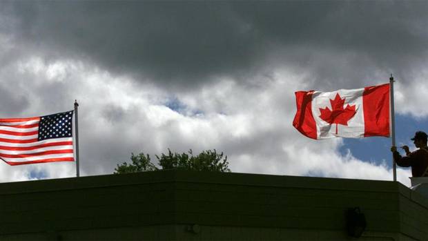 U.S. and Canadian flags at the Reversing Falls Information Centre in Saint John. (DAVID NICKERSON/CP)