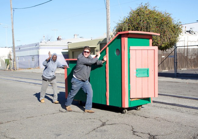 the artist and a future resident move the painted structure throughout the city