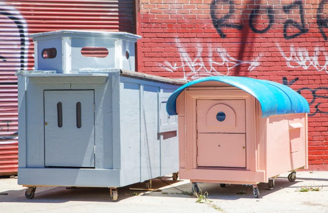 two colorfully painted structures made by the homeless homes project