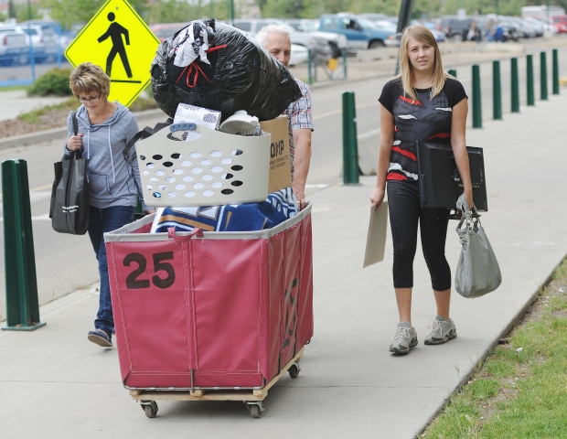 Alanna Craig, 18, from Westlock had help from her parents Shirley and Jim moving into the residence at MacEwan University downtown on Aug. 24, 2014. Photograph by: John Lucas , Edmonton Journal