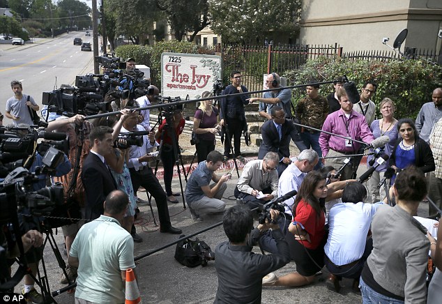 Manager of the Ivy Apartments, Sally Nuran, far right, answers questions about the quarantined family and cleaning process at the complex in North Dallas during a news conference on Thursday