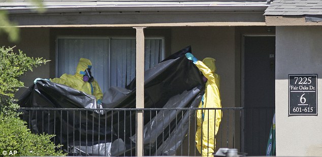 Hazardous material cleaners prepare to hang black plastic outside the apartment in Dallas today where Thomas Eric Duncan, the Ebola patient who traveled from Liberia to Dallas, stayed last week. The family living there has been confined under armed guard while being monitored by health officials for Ebola symptoms Read more: http://www.dailymail.co.uk/news/article-2780209/Ordeal-Dallas-Ebola-apartment-comes-end-Quarantined-family-moved-secret-location-Hazmat-team-arrived-FIVE-DAYS-victim-diagnozed.html#ixzz3FNfvlNQE