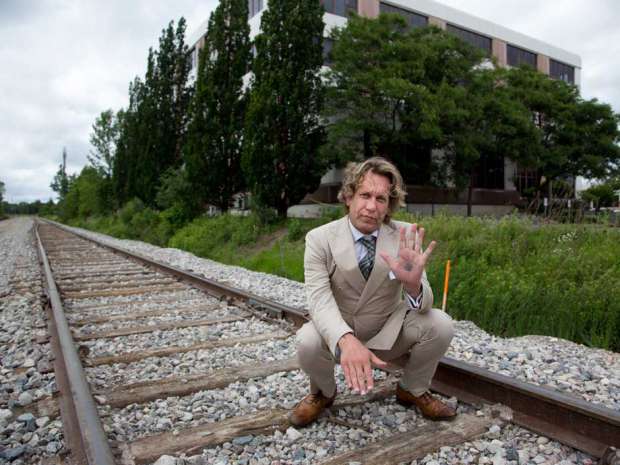Former Bay St. trader Michael Wekerle, stands near one of the buildings he owns in Waterloo, Ont.